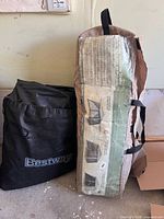 Ozark Trail canopy bag standing next to Bestway pump bag