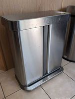 Front view of stainless steel dual compartment bin