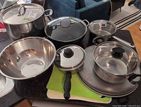 overview of all cookware, mixing bowl, cutting boards, lids and pans