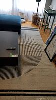 Full view of rug under furniture showing overall design and size context