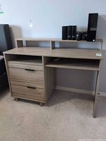 Front view of desk showing hutch, drawers, shelves, finish