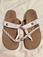 Top view of both sandals showing overall design, braided strap, and wear