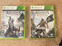 Front covers of both Xbox 360 Assassin's Creed games
