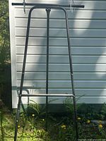 front view of black steel A-frame easel with hooks attached