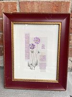 Front view of framed botanical print showing artwork and burgundy frame