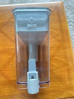 Front view of Brita dispenser showing clear body, internal reservoir and spigot