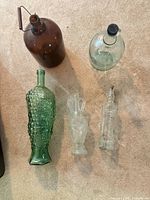 All five glass bottles laid out to show variety