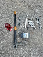 All items laid out: Fiskars weeder, red glass feeder, wind chime tubes and disks, metal planter