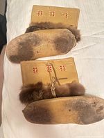soles showing wear and beaded shaft detail