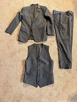 Jacket, vest and trousers laid out showing complete suit