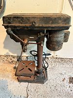 Front view of Jobmate drill press showing column, base, table, motor housing and cord