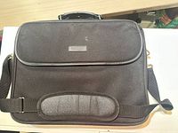 Front view showing Kensington logo, front flap, shoulder strap with pad