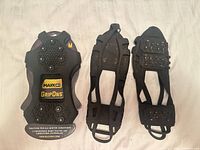 Front view showing packaged MaxxDry GripOns cleats and both loose GripOns ice grips