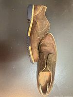 Pair of brown suede/leather wingtip shoes side and top view
