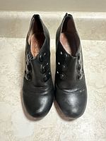 Top view of both boots showing button detail and overall wear