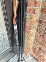 Umbrella closed in sleeve showing rifle-stock handle