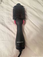 Full view of Revlon hot air brush blow dryer showing brush head and handle