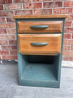 Front view showing two drawers, open shelf, paint wear