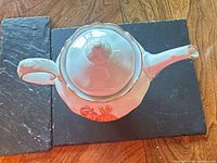Top view of teapot showing lid shape, spout and handle