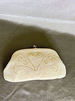 front view showing beaded scroll heart design