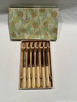 Box opened showing six knives neatly arranged