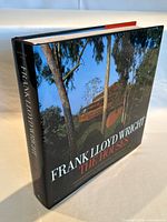 Oblique view showing dust-jacketed hardcover book spine and front