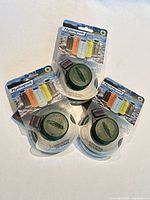 Front view of three sealed Hydrapak Stash 750 ml green bottles in packaging
