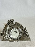 Front view showing golf motif design and clock face