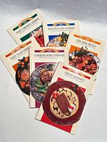 All six cookbooks fanned out showing covers