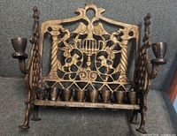 Front view showing complete menorah with decorative backplate, side arms and eight oil cups