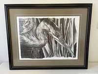 Front view of framed graphite drawing showing heron subject, mat and frame