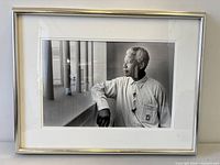 Framed black-and-white photograph of Nelson Mandela in cell