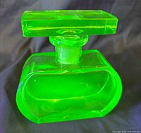 Front view of uranium glass perfume bottle showing body and stopper