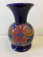 Front view of cobalt blue baluster vase with fruit decoration