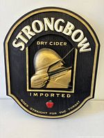 Front view of Strongbow Dry Cider figural sign displaying archer figure and lettering