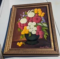 Framed floral oil painting angled view
