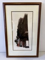 Full front view of framed etching showing artwork, mat and frame