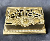 Top view showing pierced floral lid and brass finish