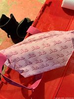 Front view of pink Barbie pattern fanny pack