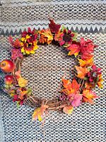 Grapevine wreath with fall leaves, flowers, berries and faux apples