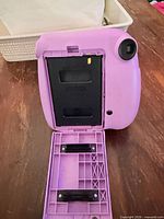 Back of purple Instax Mini 7+ with film door open