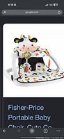 Stock image of assembled Fisher-Price Sit-Me-Up Floor Seat showing cow design and multicolour seat fabric