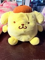 Yellow round plush dog front view