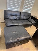futon sofa bed with ottoman, angled view