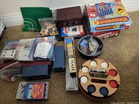 Overall lot showing boxed games, poker chip carousel, various card and dice games