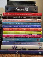 Front view of full stack showing binder and all cookbook spines