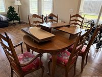 Table with six chairs and leaves placed on top