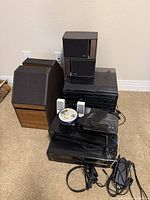 Overall shot of stacked audio components, speakers, cords