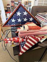 Patriotic items including framed flag, folded flags