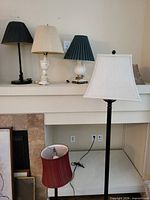 Group shot of all five lamps on and below mantel